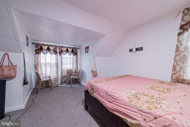carpeted bedroom featuring lofted ceiling