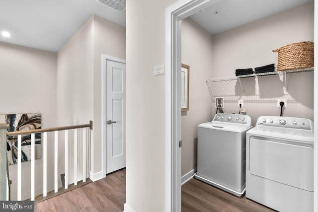 laundry room featuring wood finished floors, visible vents, separate washer and dryer, and laundry area