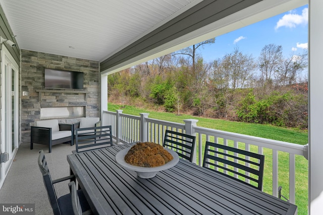 exterior space featuring outdoor dining space and a fireplace