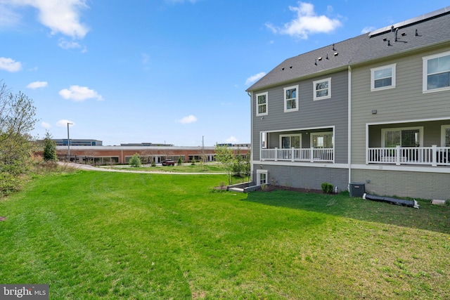 back of property with a yard and cooling unit
