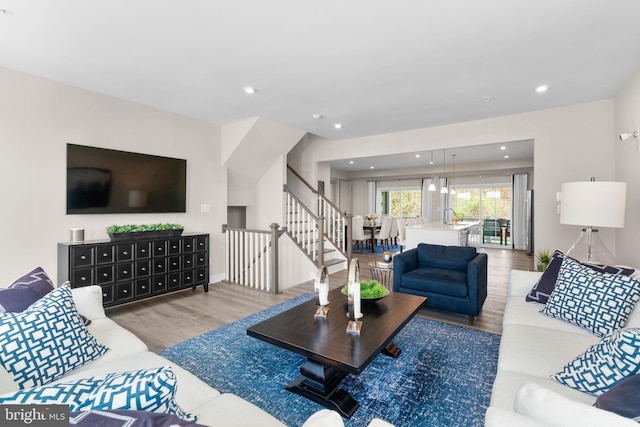 living room featuring stairs, wood finished floors, and recessed lighting