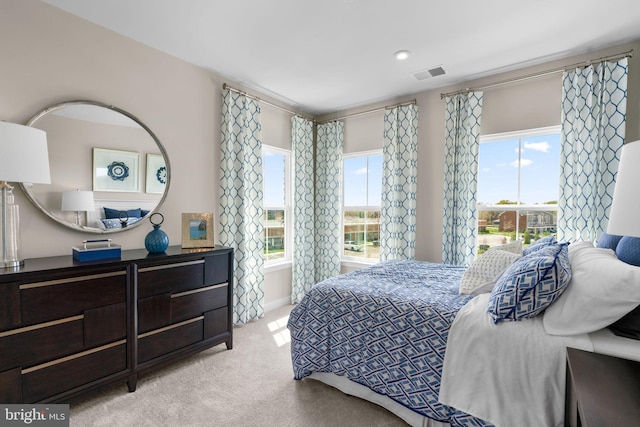 bedroom with light carpet and visible vents