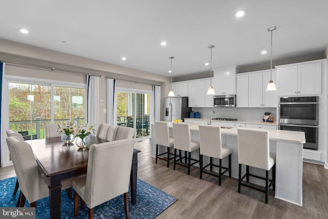 dining area with recessed lighting and dark wood-style flooring
