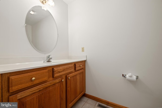 bathroom featuring visible vents, baseboards, tile patterned flooring, and vanity