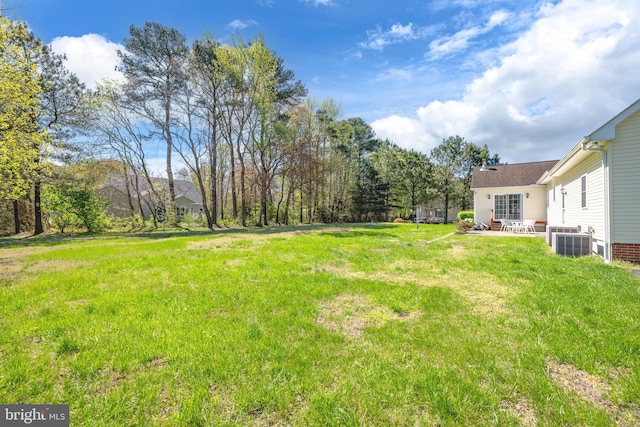 view of yard featuring a patio area and central AC