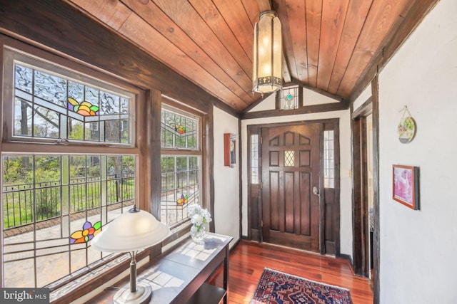 entrance foyer with lofted ceiling, wood finished floors, and wood ceiling