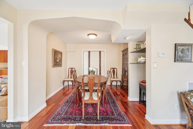 dining area featuring baseboards and wood finished floors