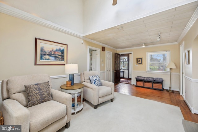 sitting room with wood finished floors and ornamental molding