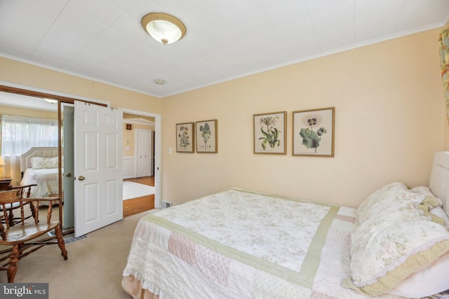 carpeted bedroom featuring crown molding