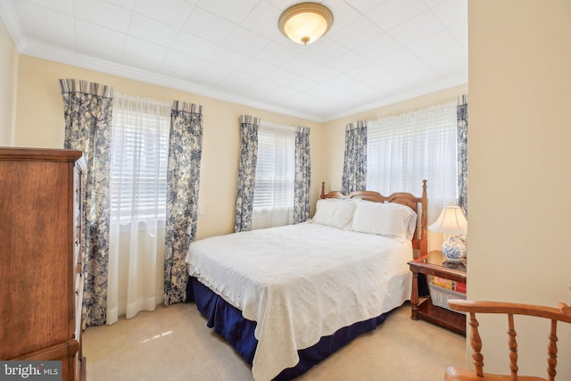 carpeted bedroom with ornamental molding