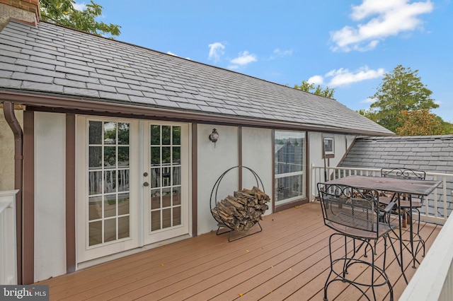 deck with french doors and outdoor dining space
