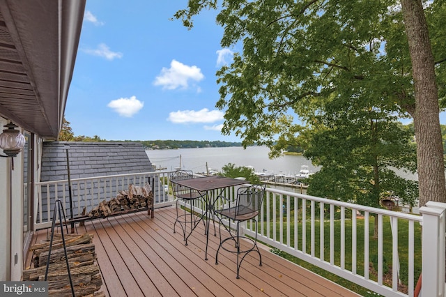 deck featuring a lawn and a water view