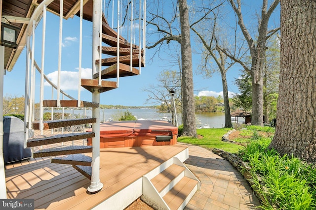 dock area with a covered hot tub, a patio area, a deck with water view, and stairs