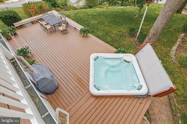 wooden deck with a yard, fence, and outdoor dining space