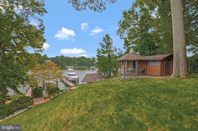 view of yard with a dock and a water view