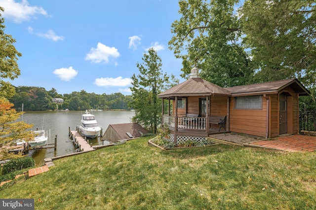 dock area featuring a lawn, a water view, and boat lift