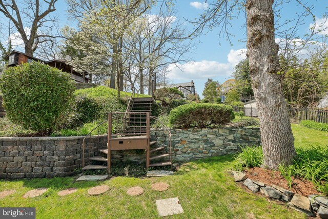 view of yard featuring stairs and fence