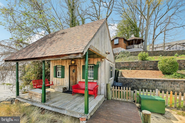 view of outbuilding with an outdoor structure and fence