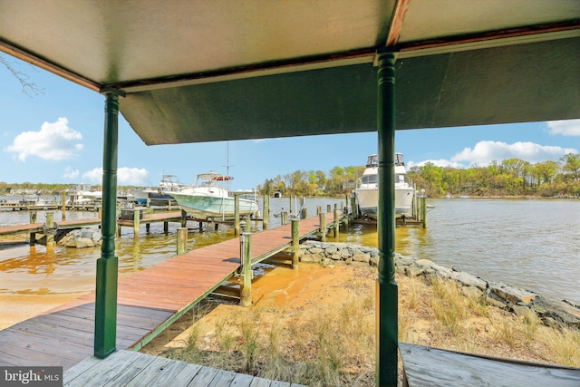 dock area featuring boat lift and a water view