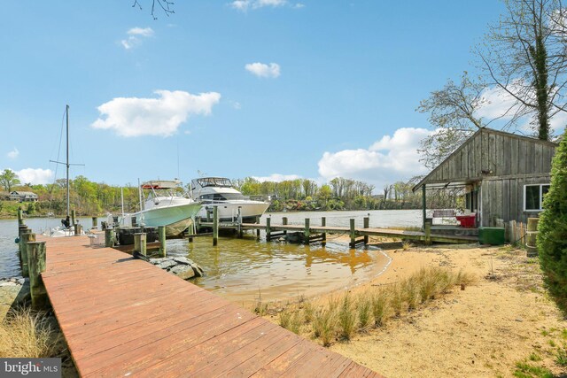 dock area featuring boat lift and a water view