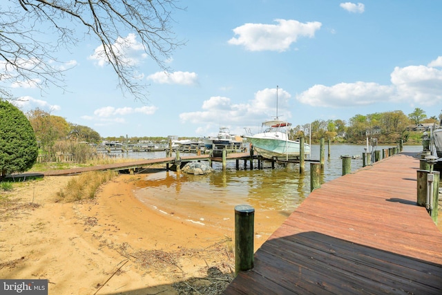 dock area featuring boat lift and a water view