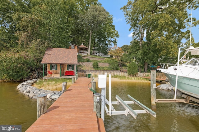view of dock featuring boat lift and a water view