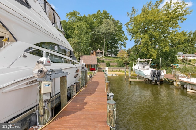 view of dock with boat lift and a water view