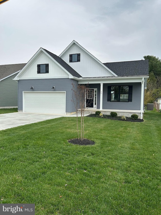view of front of property with driveway, a front yard, a porch, central AC unit, and a shingled roof
