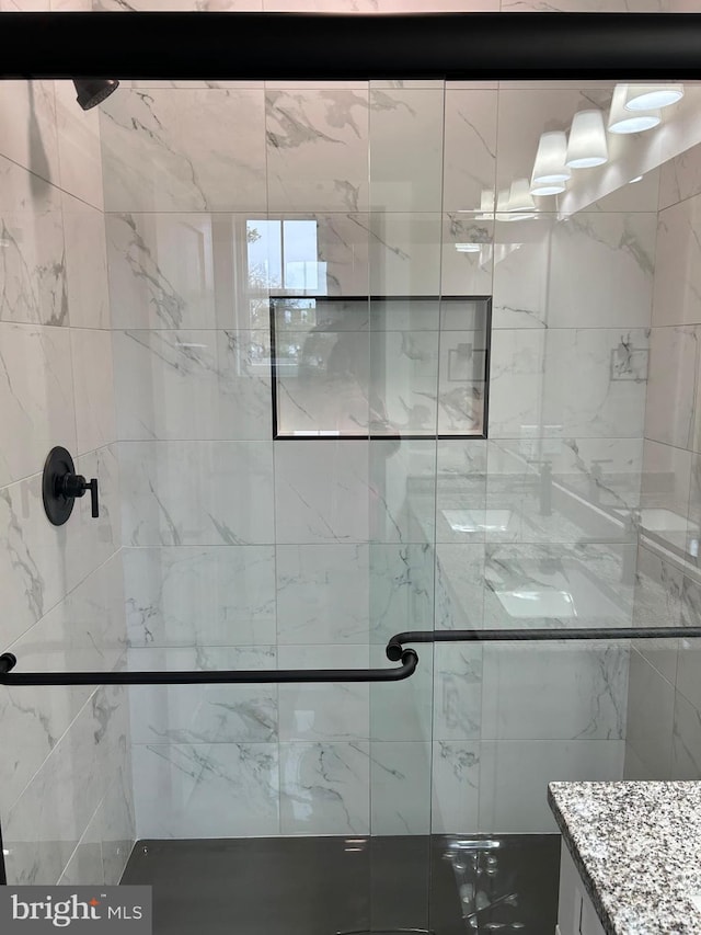 bathroom with a stall shower and vanity