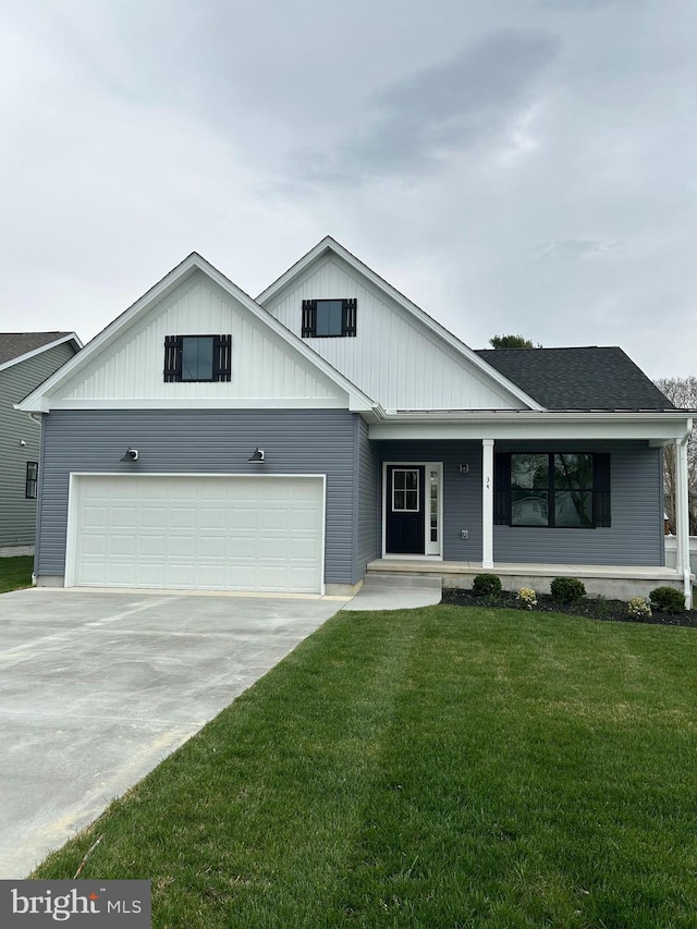 ranch-style house with a front yard, a porch, a garage, board and batten siding, and concrete driveway