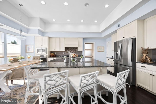 34851 Surfsong Lndg, Millville, DE 19967 - kitchen featuring recessed lighting, decorative backsplash, stainless steel appliances, and a breakfast bar