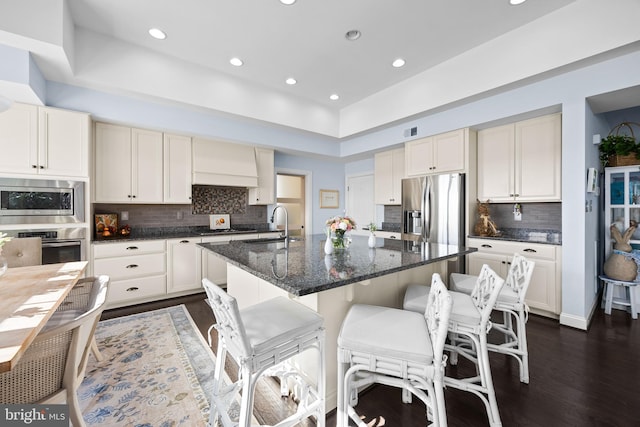 34851 Surfsong Lndg, Millville, DE 19967 - kitchen featuring recessed lighting, stainless steel appliances, backsplash, custom exhaust hood, and dark wood-style flooring