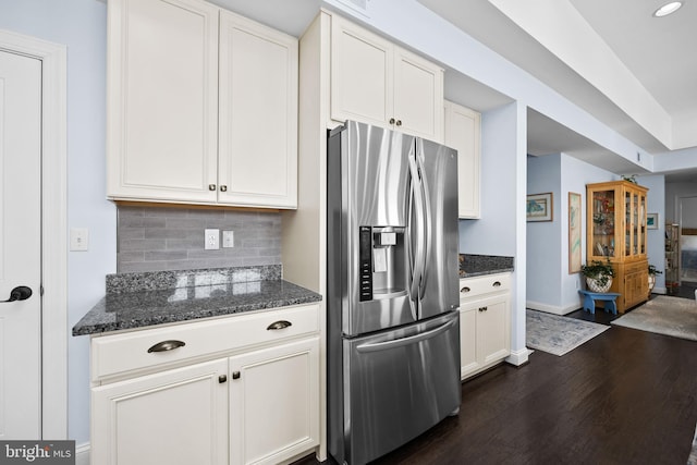 34851 Surfsong Lndg, Millville, DE 19967 - kitchen featuring stainless steel fridge, dark stone countertops, dark wood-style flooring, baseboards, and backsplash