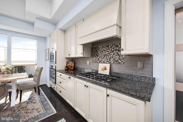 34851 Surfsong Lndg, Millville, DE 19967 - kitchen with stainless steel appliances, dark wood-style floors, dark stone counters, tasteful backsplash, and baseboards