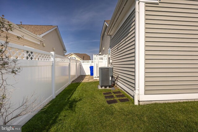 34851 Surfsong Lndg, Millville, DE 19967 - view of home's exterior with a lawn, a fenced backyard, and central AC unit