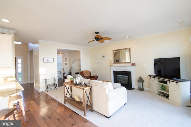 520 Bayside Dr, Stevensville, MD 21666 - living room with a fireplace with flush hearth, recessed lighting, crown molding, and ceiling fan with notable chandelier