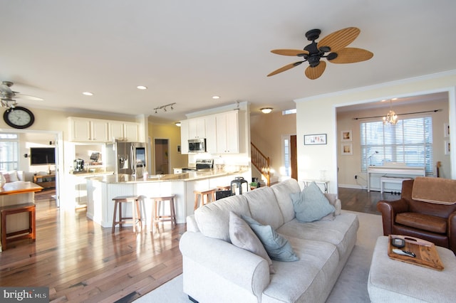 520 Bayside Dr, Stevensville, MD 21666 - living room featuring stairs, a ceiling fan, crown molding, and a wealth of natural light