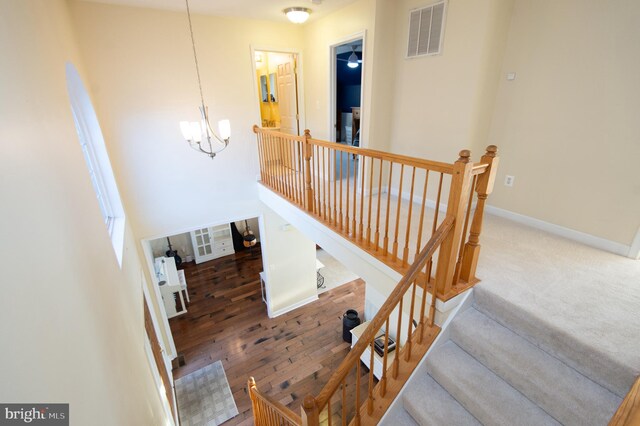 520 Bayside Dr, Stevensville, MD 21666 - stairs featuring visible vents, baseboards, and a notable chandelier