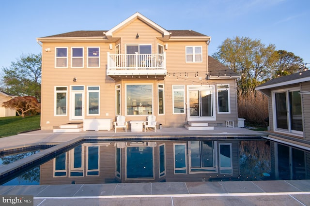 520 Bayside Dr, Stevensville, MD 21666 - rear view of house with an outdoor pool, a balcony, and a patio