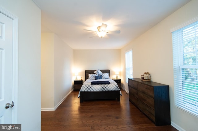 520 Bayside Dr, Stevensville, MD 21666 - bedroom featuring baseboards, a ceiling fan, dark wood-style floors, and multiple windows