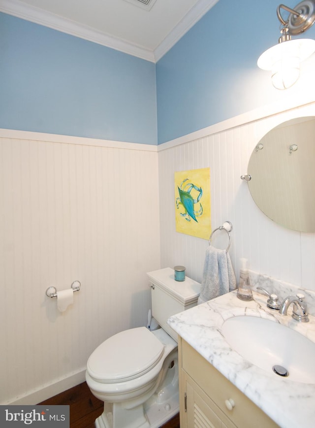 520 Bayside Dr, Stevensville, MD 21666 - bathroom with a wainscoted wall, toilet, wood finished floors, vanity, and ornamental molding