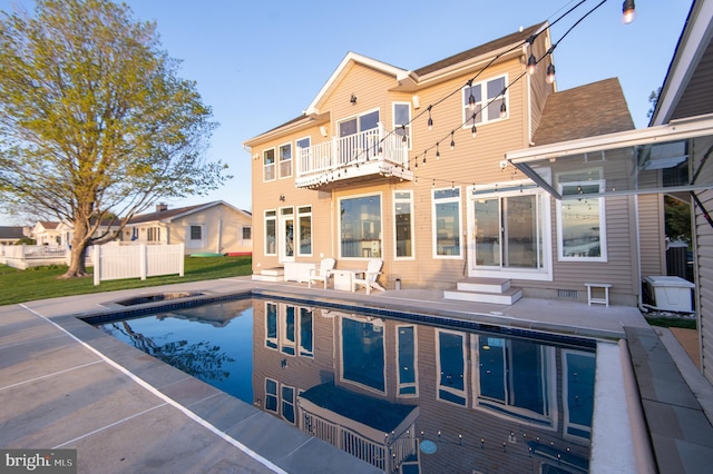 520 Bayside Dr, Stevensville, MD 21666 - back of property with entry steps, a patio area, a fenced in pool, and a balcony