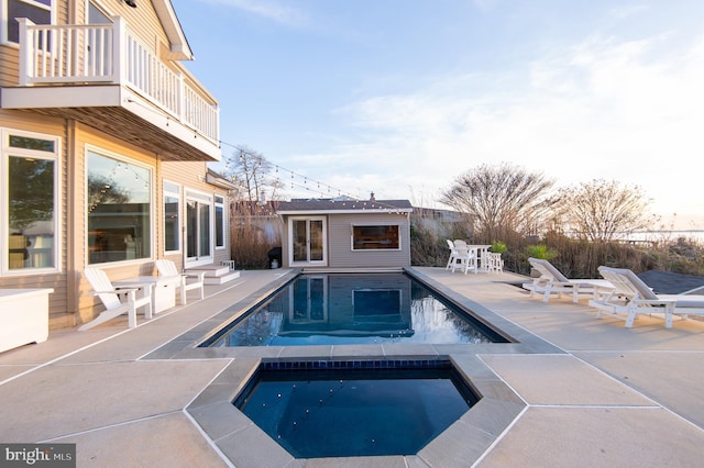 520 Bayside Dr, Stevensville, MD 21666 - pool featuring a patio area, an outbuilding, a storage structure, and an in ground hot tub