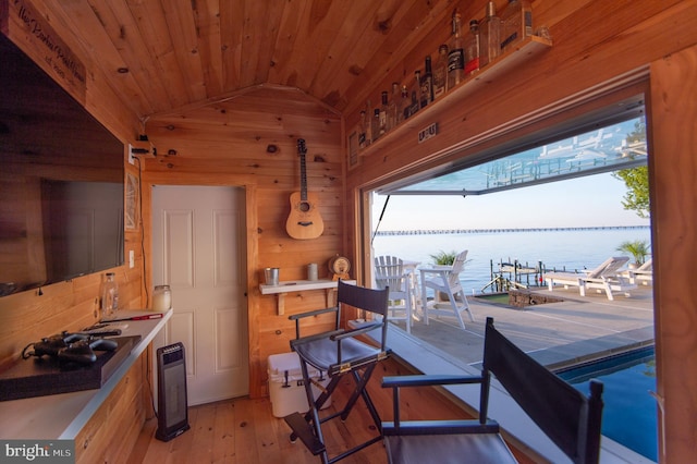 520 Bayside Dr, Stevensville, MD 21666 - interior space featuring lofted ceiling, wooden walls, a water view, wood ceiling, and light wood-style flooring