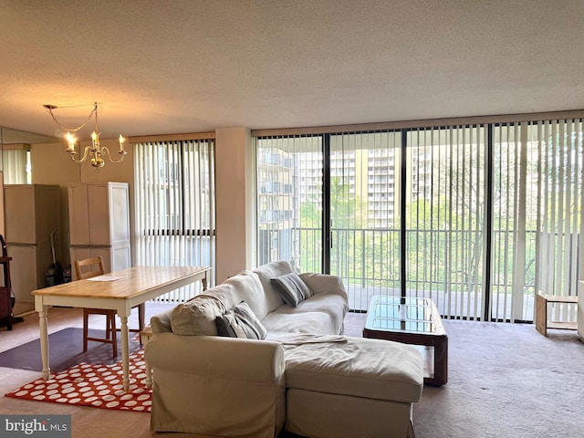 carpeted living room featuring a textured ceiling, a chandelier, and a healthy amount of sunlight
