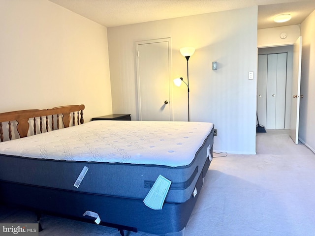 bedroom featuring baseboards and carpet