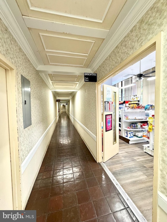 corridor with wallpapered walls, ornamental molding, tile patterned flooring, and electric panel