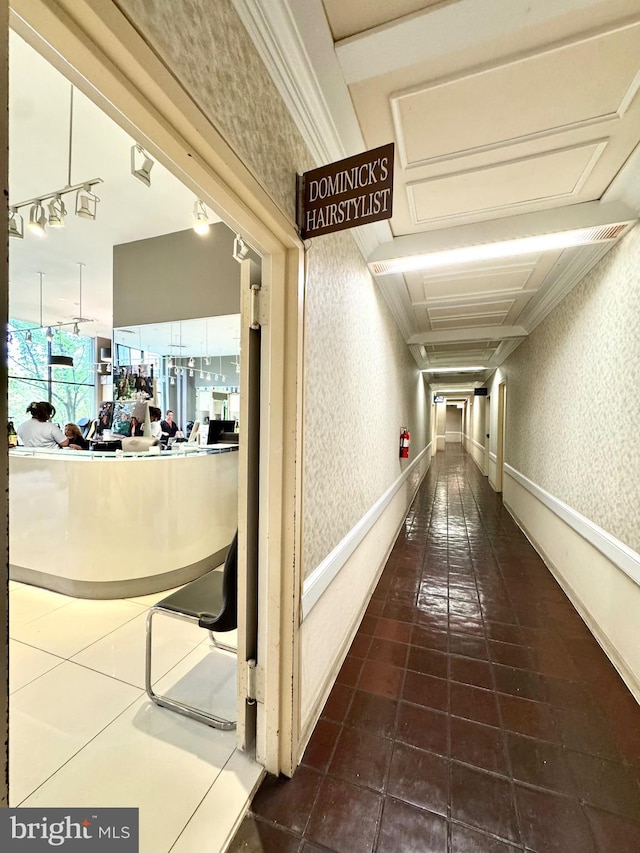 hallway with dark tile patterned flooring and wallpapered walls