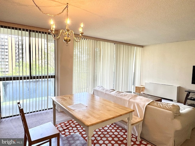 dining room featuring carpet floors, a textured ceiling, radiator, and a notable chandelier