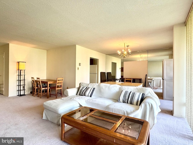carpeted living area with a textured ceiling and a chandelier
